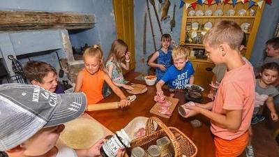 Children with ingredients in the Ancient House kitchen
