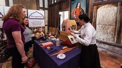 People looking at a display of historic artifacts 